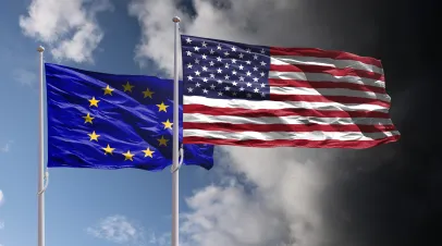 EU and USA flags above dark sky. Europe Union and United States of America trade, tariffs and political confrontation