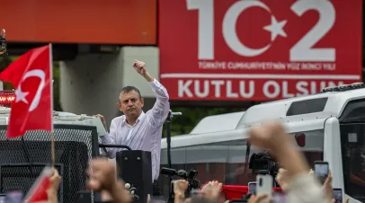 Turkey’s main opposition Republican People's Party's (CHP) Ousted party leader Ozgur Ozel waves to supporters from atop a police water cannon vehicle after being forcibly evicted by police from his party’s headquarters on May 24, 2026 in Ankara, Turkey. 