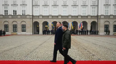The President of Poland, Karol Nawrocki and the President of Ukraine, Volodymyr Zelensky walk together during a welcome ceremony at the Presidential Palace on December 19, 2025 in Warsaw, Poland. 
