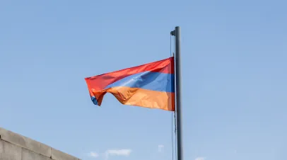 Armenian flag, the flag of Armenia on the blue sky background.