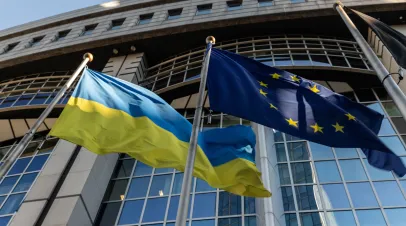 Ukrainian flag and European Union flag in front of the European Parliament