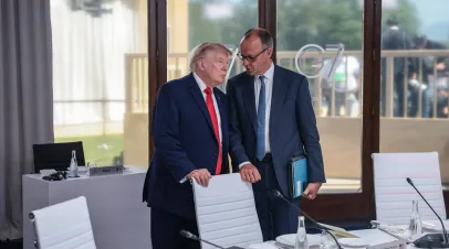 EVIAN-LES-BAINS, FRANCE - JUNE 16: U.S. President Donald Trump speaks with German Chancellor Friedrich Merz at a working lunch with leaders of G7 and the Middle East, on June 16, 2026 in Evian-les-Bains, France. Leaders from the Group of 7 (G7) countries convened in Evian, France, near the Swiss border, for their annual summit to discuss challenges to peace and security for Ukraine and Europe, the situation in the Middle East, and other geopolitical issues. 
