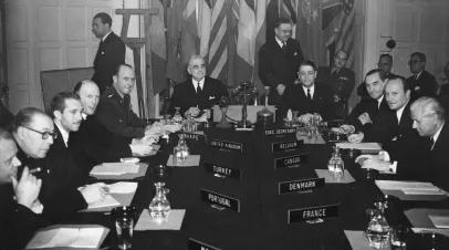 April 1952: General Lord Ismay (1887 - 1965 ) the English soldier known as 'Pug' is attending a ceremony at the North Atlantic Treaty Organisation ( NATO ) Headquarters in Belgrave Square as the new secretary-general. It is the third annivesary of the signing of the treaty and he is pictured at the head of the table with Mr Charles Spofford, chairman of the council of deputees on his right.