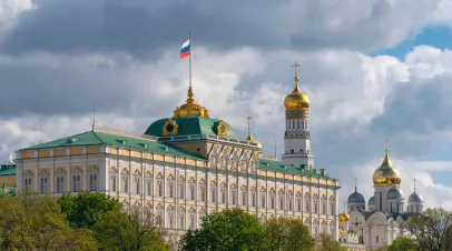 Grand Kremlin Palace with the national flag of Russia, Ivan the Great bell tower and Archangel Cathedral