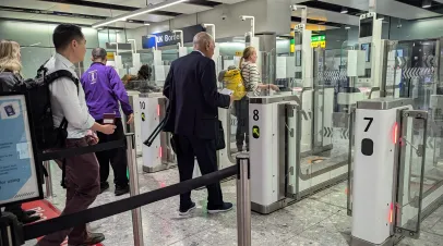 Air travellers pass through automated passport border control e-gates at Heathrow Airport on November 24, 2025 in London, UK. The aviation hub is the biggest in Europe by passenger volume.