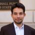 Marton's headshot in front of the GMF sign outside the DC office building.