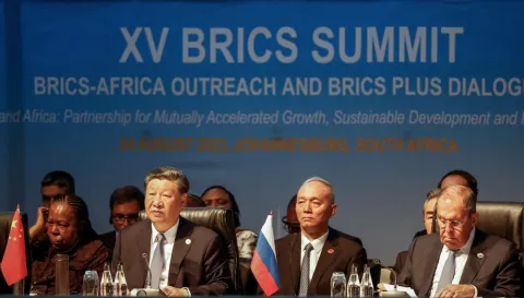 Chinese leader Xi Jinping, left, and Russian Foreign Minister Sergei Lavrov, right, attend the BRICS summit in Johannesburg