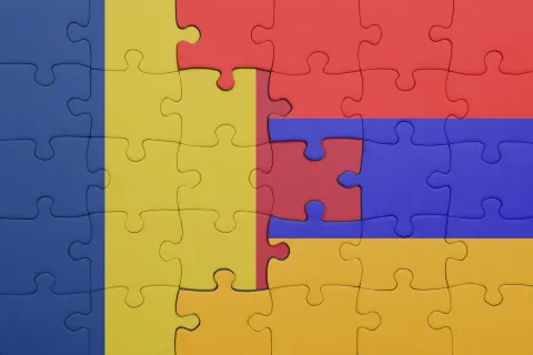 Puzzle with the colorful national flag of Romania and flag of Armenia.