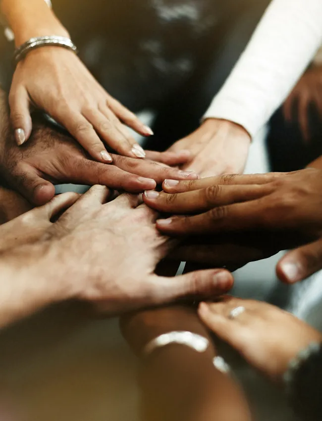 Diverse group of people joining their hands