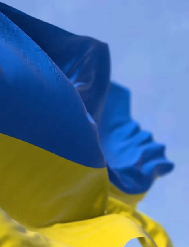Detail of the national flag of Ukraine waving in the wind on a clear day.