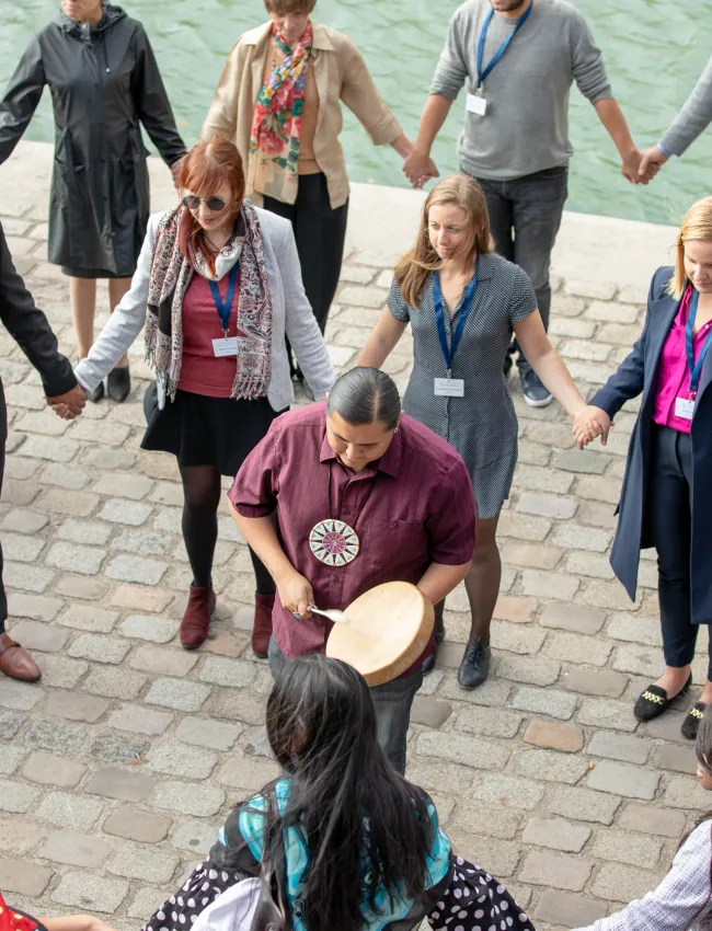 Inclusive Leadership Summit people in a circle holding hands
