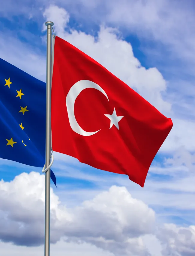 European Union and Republic of Türkiye Flags Over Blue Sky Background. 3D Illustration