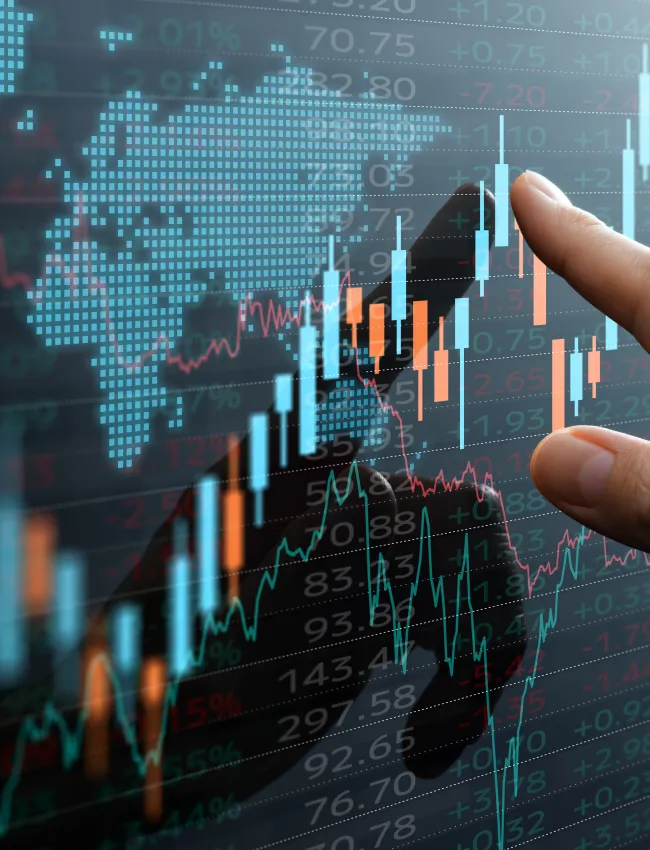 Graphs and world financial markets data. Investor pointing at the candlestick chart.
