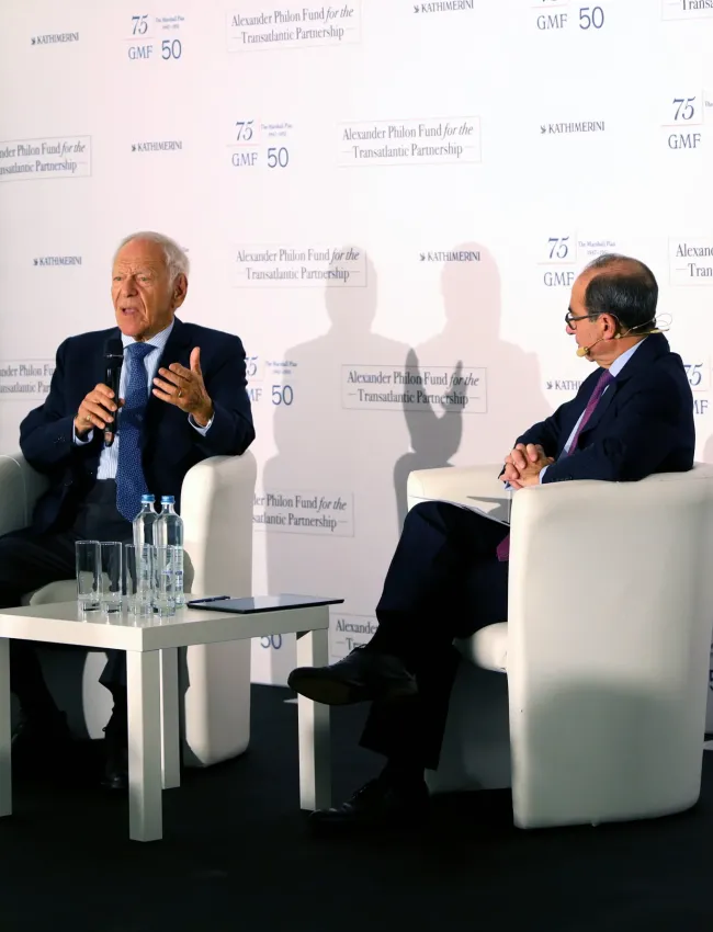 Two men speaking on a stage