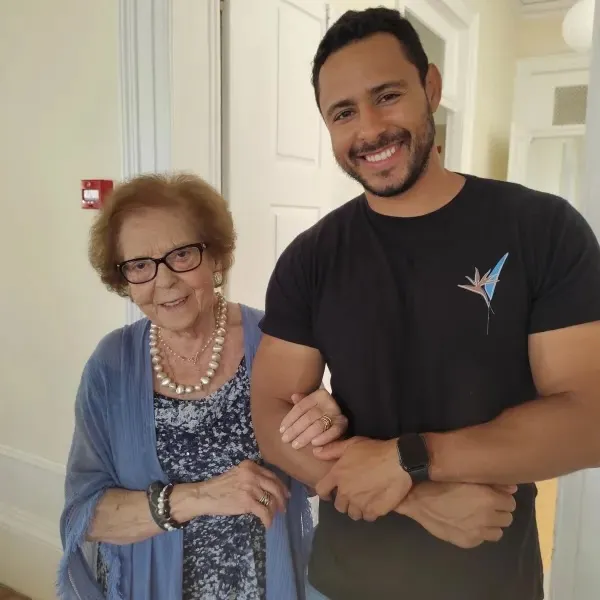 Young man standing with older woman