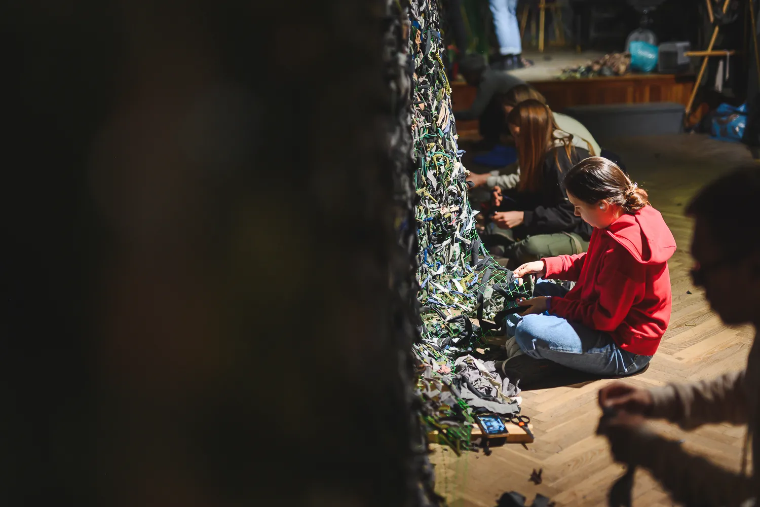 Volunteers weave camouflage nets for the military in the Powder Tower. Lviv, Halychyna. 10 March 2022