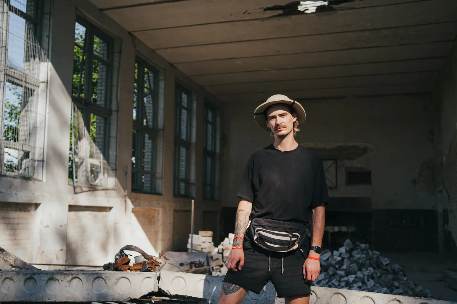 Portrait of Oleksandr Kuchynskyi, co-founder of Repair Together volunteer initiative, during a toloka (joint work) at the damaged Culture house. Yahidne, Sivershchyna. 23 July, 2022